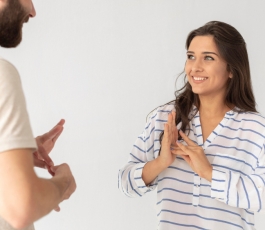 casual man woman communicating through sign language